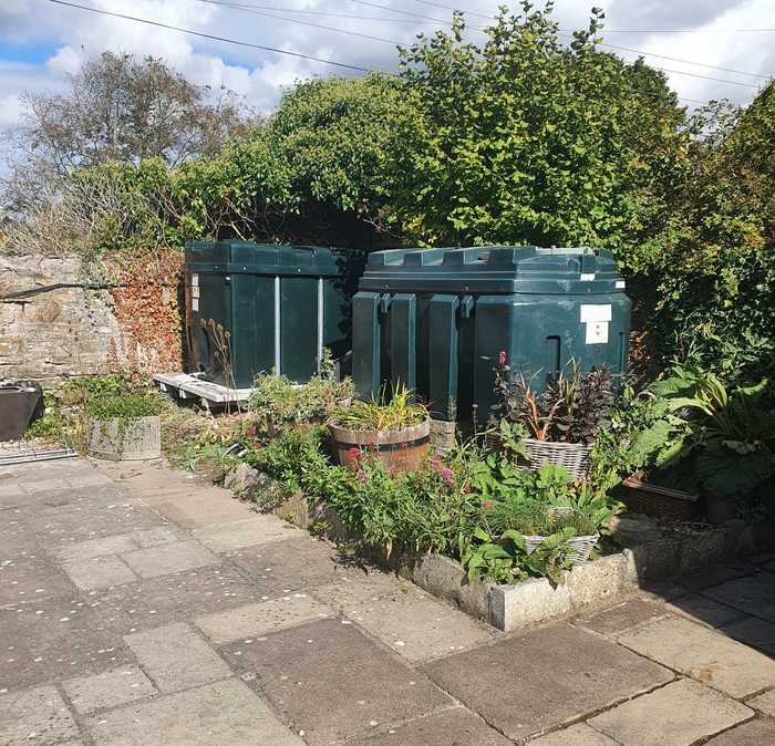 oil tanks with potted plants and trees